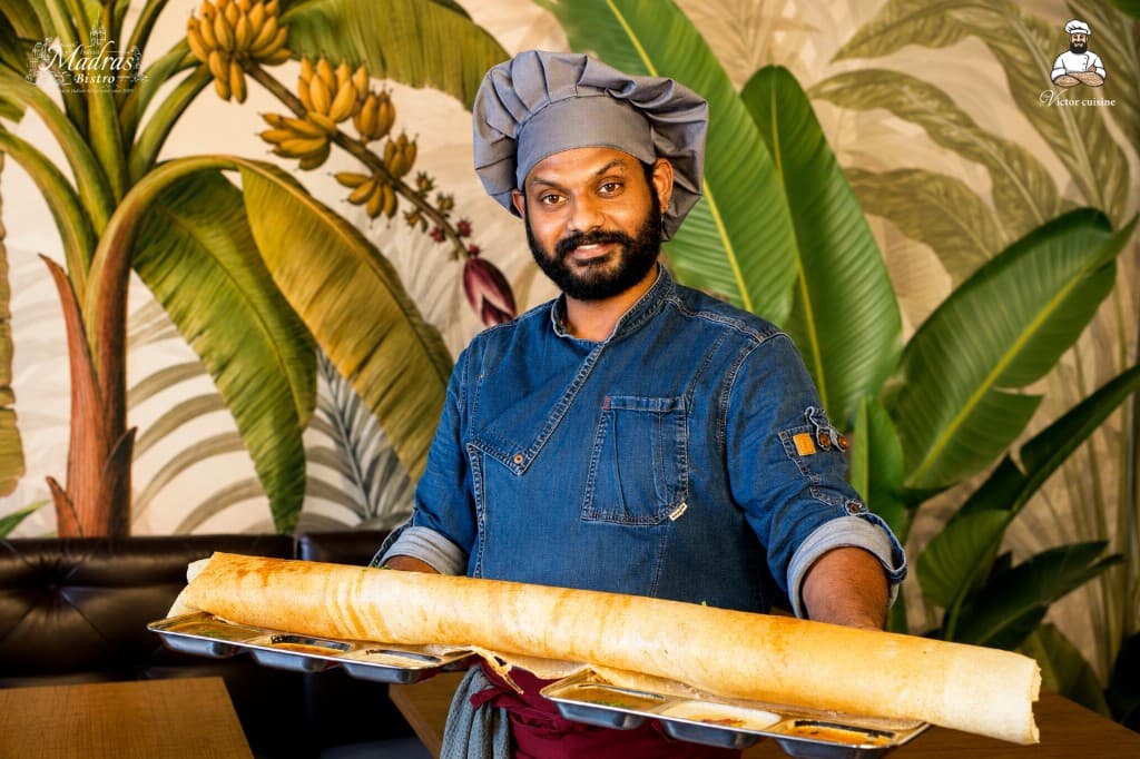 Chef Victor presenting a signature paper dosa at Madras Bistro